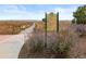 Scenic walking path through Metzger Farm Open Space with native plants, rolling hills, and informative signage at 12453 Knox Ct, Broomfield, CO 80020