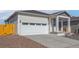 Charming home featuring a two car garage, concrete driveway, and well-maintained landscaping at 18338 E 93Rd Pl, Commerce City, CO 80022