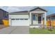 Charming single-Gathering home featuring a two-car garage and welcoming front porch at 18338 E 93Rd Pl, Commerce City, CO 80022