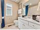 Well-lit bathroom showcasing modern fixtures, a decorative vanity, and a framed mirror over the sink at 3373 N Catawba Way, Aurora, CO 80019