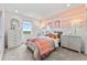 Charming bedroom showcases a peach accent wall, window views, and stylish decor for a cozy retreat at 3373 N Catawba Way, Aurora, CO 80019