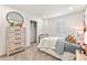 Bright bedroom featuring a wooden dresser, closet, shuttered window, and adorable decor at 3373 N Catawba Way, Aurora, CO 80019