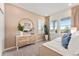 Inviting bedroom featuring neutral tones, large windows, and stylish decor with a decorative mirror and plants at 3373 N Catawba Way, Aurora, CO 80019