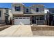 Charming two-story home featuring a spacious garage, stone accents, and a welcoming front porch at 3373 N Catawba Way, Aurora, CO 80019