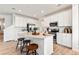 Modern kitchen featuring white cabinetry, stainless steel appliances, and an island with seating, perfect for entertaining and cooking at 3373 N Catawba Way, Aurora, CO 80019