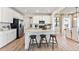 Modern kitchen with white cabinets, stainless steel appliances, a large center island, and stylish bar stools, perfect for casual dining at 3373 N Catawba Way, Aurora, CO 80019