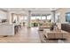 Open-concept living room with natural light, seamless flow from kitchen to the outdoor patio, and modern, comfortable furnishings at 3373 N Catawba Way, Aurora, CO 80019