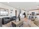 Bright open-concept living room with wood floors, modern decor, and white kitchen in a contemporary style home at 3373 N Catawba Way, Aurora, CO 80019