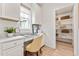 Charming home office space with white cabinets, a built-in desk, and organized pantry shelves at 3373 N Catawba Way, Aurora, CO 80019