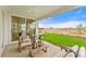 Cozy covered patio with comfortable seating, lanterns, and a tranquil view of the outdoors at 3373 N Catawba Way, Aurora, CO 80019