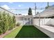 Backyard featuring artificial grass, storage shed, and carport for convenient parking at 3884 Osceola St, Denver, CO 80212