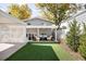 Spacious backyard with artificial turf, covered patio with modern furniture, perfect for outdoor living at 3884 Osceola St, Denver, CO 80212