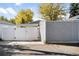 Backyard featuring a well-maintained fence and storage shed, complemented by lush greenery at 3884 Osceola St, Denver, CO 80212