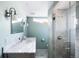 Modern bathroom with a glass shower, marble counter, and stylish fixtures at 3884 Osceola St, Denver, CO 80212