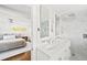 Elegant bathroom with marble counters, a glass shower, and a bedroom view at 3884 Osceola St, Denver, CO 80212
