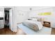Bright bedroom with hardwood floors, a ceiling fan, and natural light from two windows at 3884 Osceola St, Denver, CO 80212