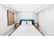 Comfortable bedroom with a blue headboard, hardwood floors, and natural light at 3884 Osceola St, Denver, CO 80212