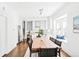 Open-concept kitchen and dining area featuring hardwood floors, white cabinets, and stainless steel appliances at 3884 Osceola St, Denver, CO 80212