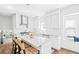 Bright kitchen with white cabinets, a large island, stainless steel appliances, and hardwood floors at 3884 Osceola St, Denver, CO 80212