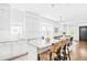 Modern kitchen featuring white cabinets, granite countertops, stainless steel appliances, and a breakfast bar at 3884 Osceola St, Denver, CO 80212