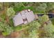 A gorgeous aerial view of a home with mature trees and well-manicured lawn at 4407 Delaware Dr, Larkspur, CO 80118