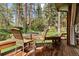 Spacious back deck with picturesque views of lush greenery and towering pine trees at 4407 Delaware Dr, Larkspur, CO 80118