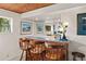 Close up of the bar area with three chairs and a mirror into another area of the home at 4407 Delaware Dr, Larkspur, CO 80118