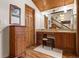 Stylish vanity area with wooden cabinets, stone countertop and wooden accents at 4407 Delaware Dr, Larkspur, CO 80118
