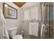 Bathroom featuring a toilet, shower with glass enclosure and framed artwork at 4407 Delaware Dr, Larkspur, CO 80118