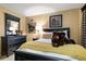 Bedroom with a black bed and dresser and a brown teddy bear adorning the bedspread at 4407 Delaware Dr, Larkspur, CO 80118