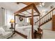Spacious bedroom with wood ceiling, canopy bed, and access to the staircase at 4407 Delaware Dr, Larkspur, CO 80118