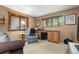 Cozy bedroom featuring neutral walls, natural light, and a comfortable seating area with a desk at 4407 Delaware Dr, Larkspur, CO 80118