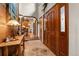 Inviting entryway featuring wood accents, tile floors and beautiful wood entry doors at 4407 Delaware Dr, Larkspur, CO 80118