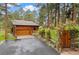 Exterior view of a charming log home with a well-manicured yard and driveway at 4407 Delaware Dr, Larkspur, CO 80118