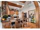 Stylish kitchen with granite countertops, a breakfast bar, and wood flooring at 4407 Delaware Dr, Larkspur, CO 80118