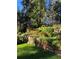 Beautiful backyard landscaping featuring a stone retaining wall with colorful flowers and plants at 4407 Delaware Dr, Larkspur, CO 80118
