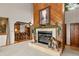 Warm and inviting living room with a wood burning fireplace and charming decor at 4407 Delaware Dr, Larkspur, CO 80118