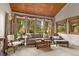 Comfortable living room with a wood ceiling, carpet, and large windows offering natural light at 4407 Delaware Dr, Larkspur, CO 80118