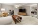 Bright and spacious living room with a comfortable sofa and an open floorplan to a game area at 4407 Delaware Dr, Larkspur, CO 80118