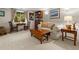 Comfortable living room with a drop leaf coffee table, bookshelf, soft white sofa and decorative wall art at 4407 Delaware Dr, Larkspur, CO 80118