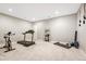 Basement home gym with treadmill and exercise bike at 12135 S Meander Way, Parker, CO 80138