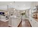 Kitchen with white cabinets, granite counters, island, and open layout at 12135 S Meander Way, Parker, CO 80138