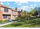 View of the exterior and the lawn surrounding the front of the townhome at 892 Summer Dr # 15B, Highlands Ranch, CO 80126