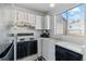 Efficient kitchen with white cabinets and black appliances, ready for updates at 892 Summer Dr # 15B, Highlands Ranch, CO 80126