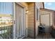 A small patio features a table, two chairs, and sliding glass doors at 892 Summer Dr # 15B, Highlands Ranch, CO 80126