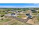 Aerial view of community homes, fenced in yards, and a large lot at 16197 Paris Way, Brighton, CO 80602