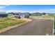 Aerial view of property with a garage, camper, trailer, and large parking area at 16197 Paris Way, Brighton, CO 80602