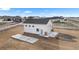 Aerial view of a barn on a large lot, featuring a concrete slab and RV parking at 16197 Paris Way, Brighton, CO 80602