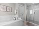 Bright bathroom showcases a walk-in shower and soaking tub with white subway tile at 16197 Paris Way, Brighton, CO 80602