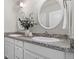Bright bathroom featuring double sinks, granite counters and decorative mirrors with white trim at 16197 Paris Way, Brighton, CO 80602